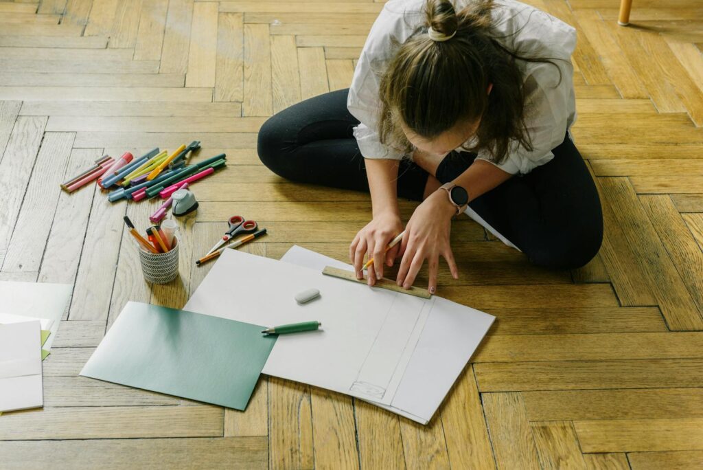 Woman in White Shirt Writing on White Paper