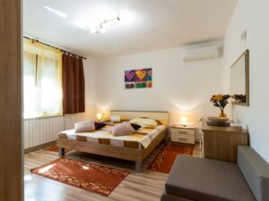 white and brown bed near brown wooden table