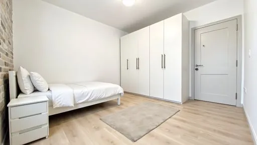 A_small_but_beautifully_styled_bedroom_with_light_pale_ash_laminate